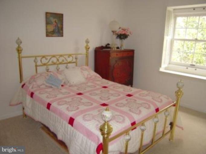 9155 Rockefeller Lane Springfield, VA 22153 - Photo 8 of 15 a bed sitting in a bedroom next to a window