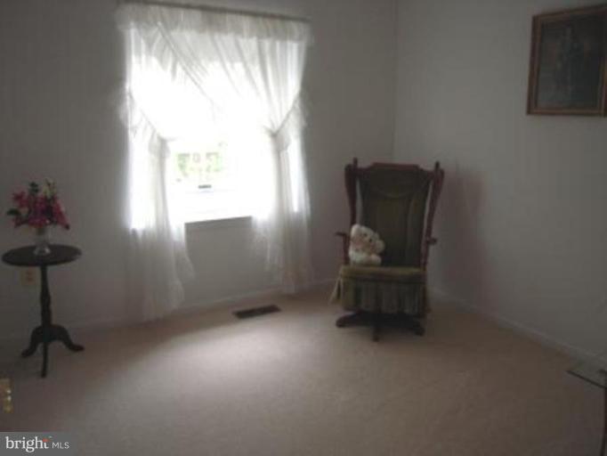 9155 Rockefeller Lane Springfield, VA 22153 - Photo 9 of 15 a living room with furniture and a window
