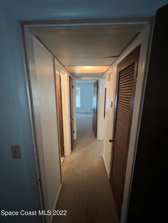 a view of hallway with stainless steel appliances
