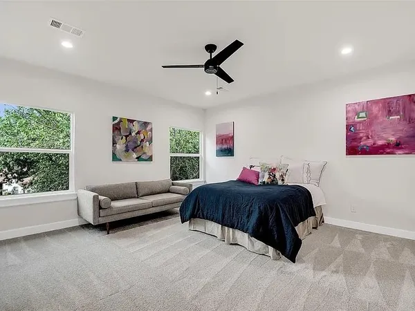 a bedroom with a bed and a ceiling fan