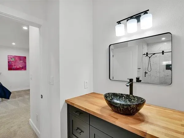 a living room with stainless steel appliances kitchen island granite countertop cabinets and flat screen tv