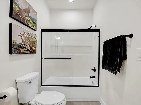 an empty room with a projector and windows