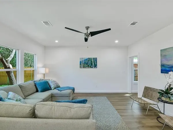 a living room with furniture and kitchen view