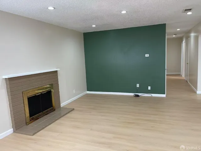 a view of an empty room with a fireplace