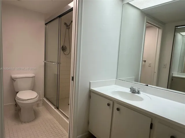 a bathroom with a toilet sink and a mirror