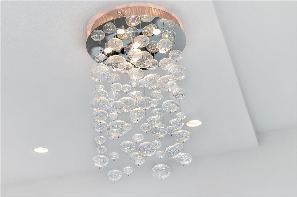 1101 Ivean Pearson Road, Unit A102 Lago Vista, TX 78645 - Photo 10 of 31 Detailed view of a chandelier and recessed lighting