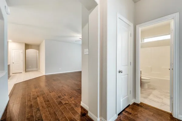 a view of a room with wooden floor and bathroom