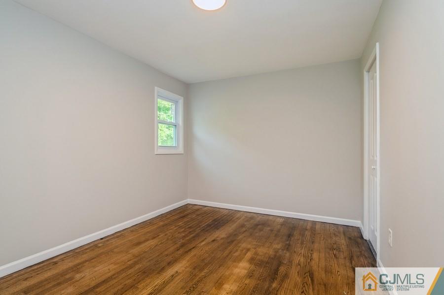 139 Tennent Road Morganville, NJ 07751 - Photo 11 of 15 a view of an empty room and window