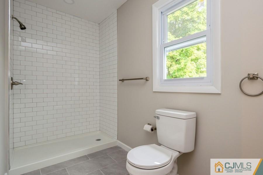 139 Tennent Road Morganville, NJ 07751 - Photo 8 of 15 a white toilet sitting next to a bath tub shower