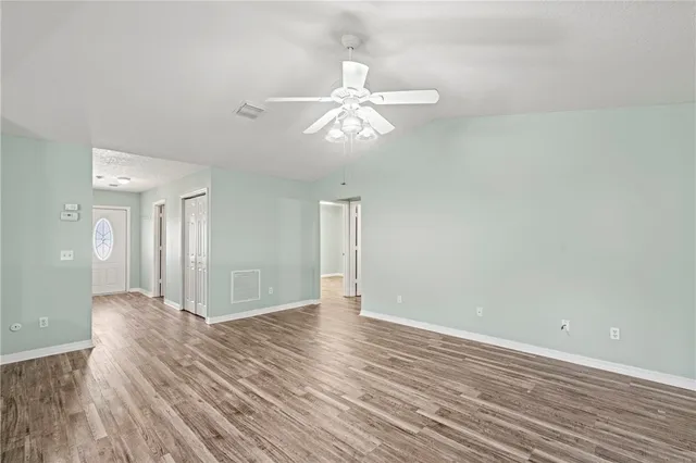 wooden floor in an empty room with a window
