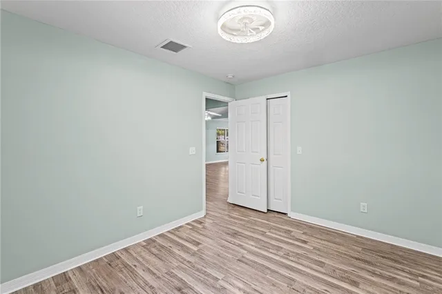 an empty room with a empty space and wooden floor