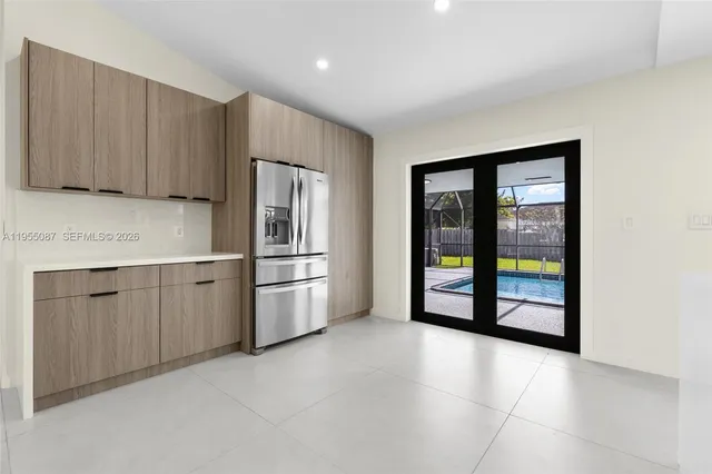 a view of a kitchen with granite countertop a sink and a window