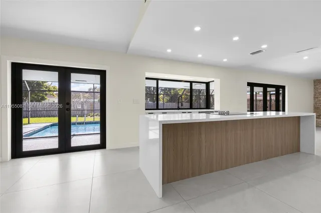 a view of a livingroom with a ceiling fan and window