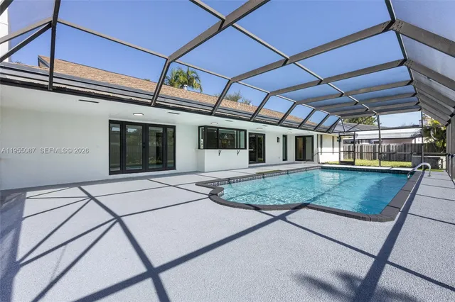 an aerial view of a house with swimming pool