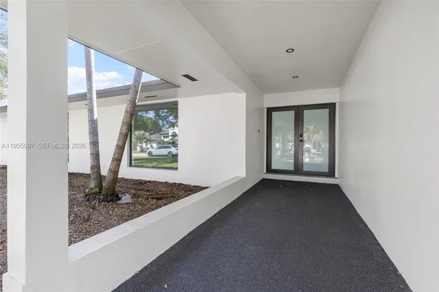 a view of a kitchen with a sink and a refrigerator