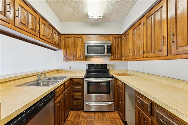 a kitchen with stainless steel appliances granite countertop a stove and a microwave