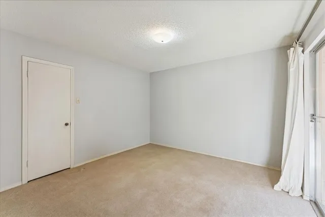 a view of a livingroom with wooden floor and a ceiling fan
