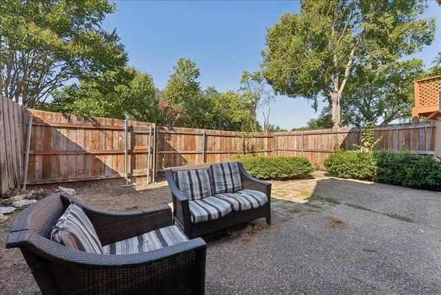 a view of a patio with couches table and chairs and potted plants