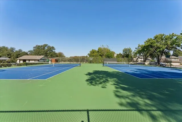 a view of a patio with table and chairs under an umbrella