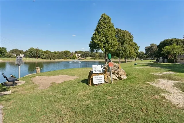 a view of a lake with houses in the background