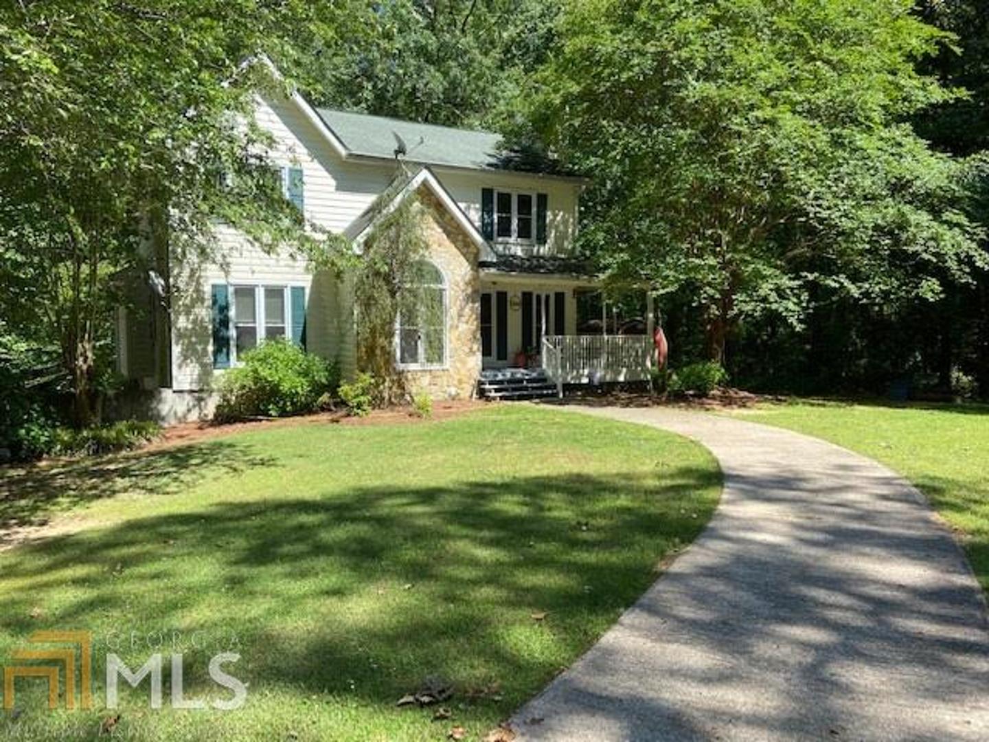 a front view of house with yard and green space