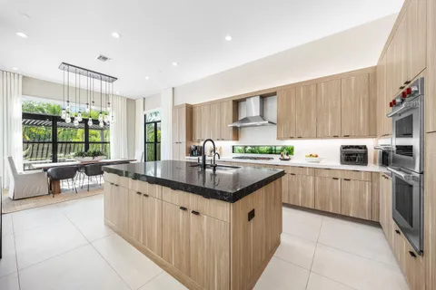 a view of a kitchen with furniture and wooden floor