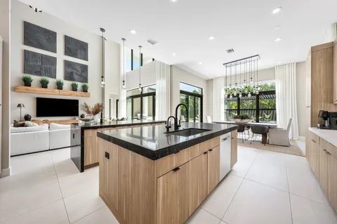 a bedroom with a bed television window and dresser