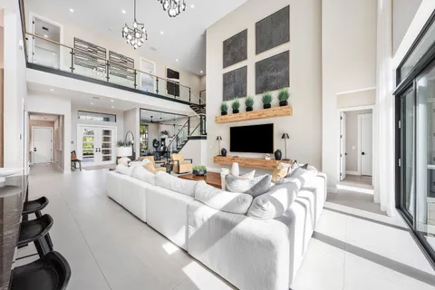 a living room with furniture a window and a chandelier