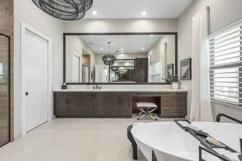 a bathroom with a double vanity sink toilet and mirror