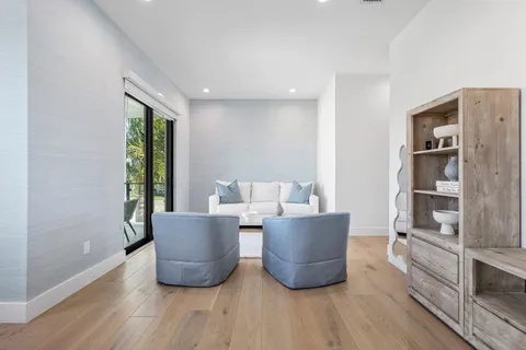 a bathroom with a shower sink vanity mirror and toilet