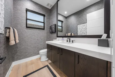 an aerial view of multiple houses with a yard