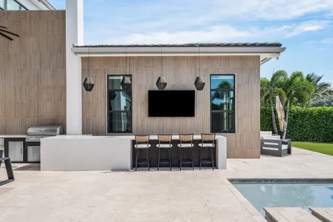 a kitchen with kitchen island granite countertop a sink a center island stainless steel appliances and cabinets