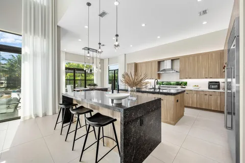 a living room with furniture kitchen view and a flat screen tv