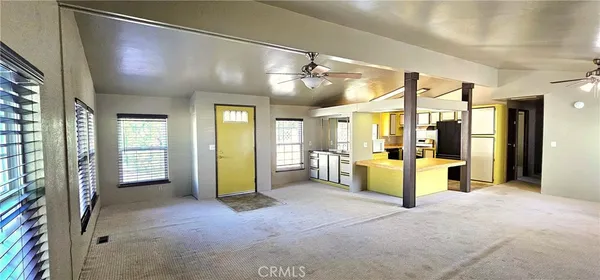 a view of a livingroom with furniture and a bathroom