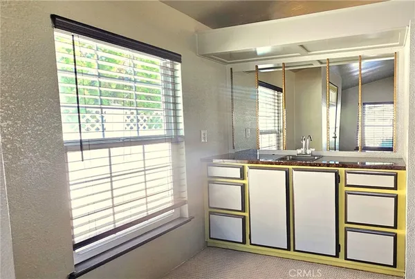 a kitchen with stainless steel appliances kitchen island granite countertop a refrigerator and a stove top oven