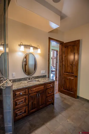 a large bathroom with a granite countertop sink and a mirror