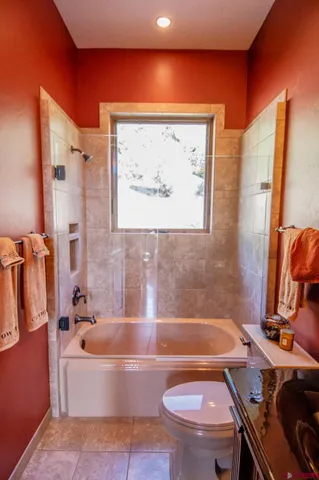 a bathroom with a sink a toilet and bathtub