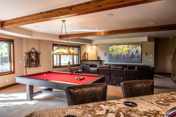 a living room with furniture gym equipment and a large window