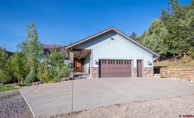 a front view of a house with a yard table and chairs