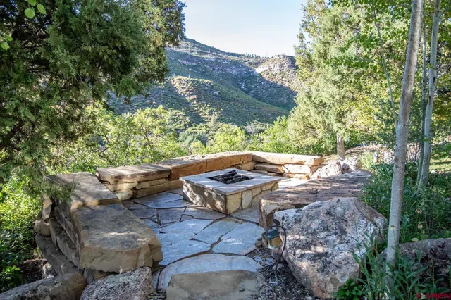 a view of backyard with plants and outdoor seating