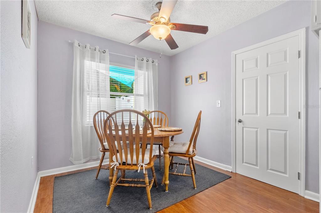 5596 100th Way North St. Petersburg, FL 33708 - Photo 22 of 67 a view of a dining room with furniture window and wooden floor