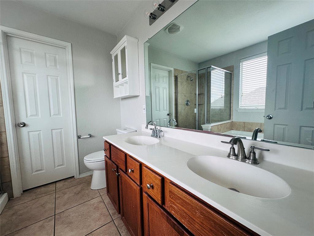 213 Spruce Trail Forney, TX 75126 - Photo 12 of 19 a bathroom with a sink and a mirror