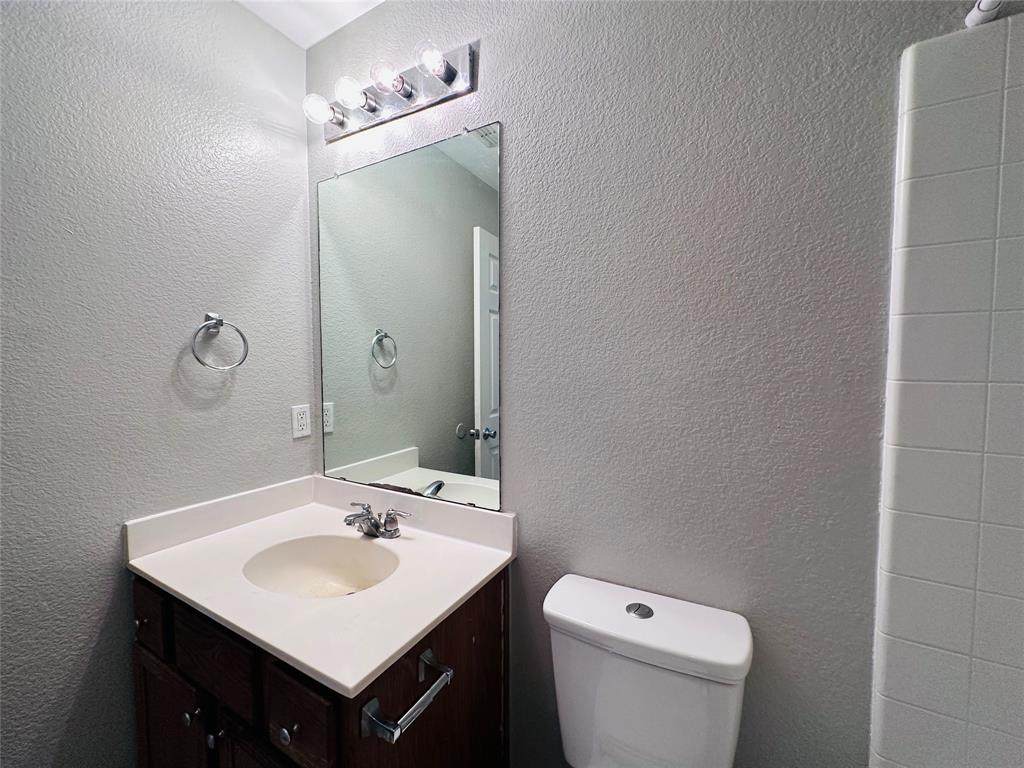 213 Spruce Trail Forney, TX 75126 - Photo 16 of 19 a bathroom with a sink toilet and mirror
