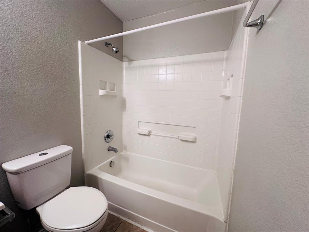 213 Spruce Trail Forney, TX 75126 - Photo 17 of 19 a white toilet sitting next to a bath tub