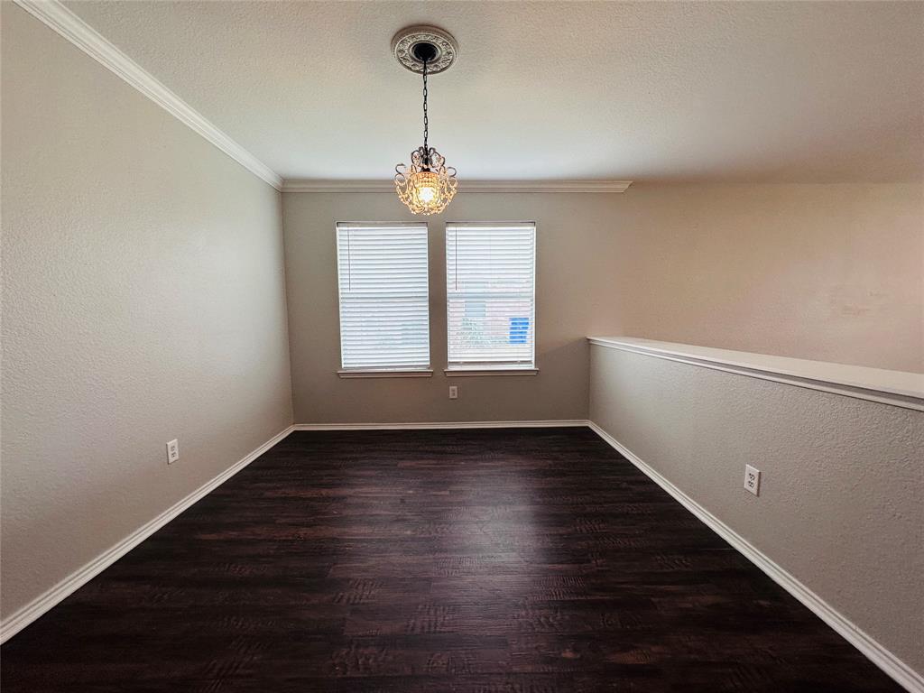 213 Spruce Trail Forney, TX 75126 - Photo 4 of 19 a view of an empty room with wooden floor and a window