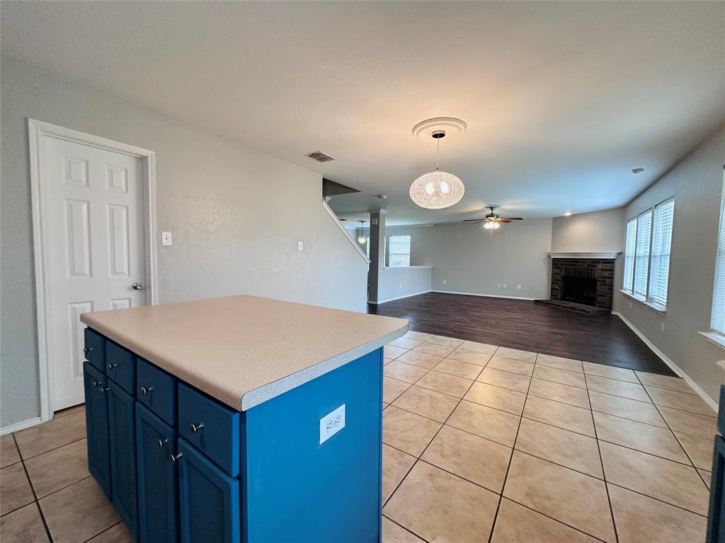 213 Spruce Trail Forney, TX 75126 - Photo 7 of 19 a kitchen with a sink a counter space and a stove