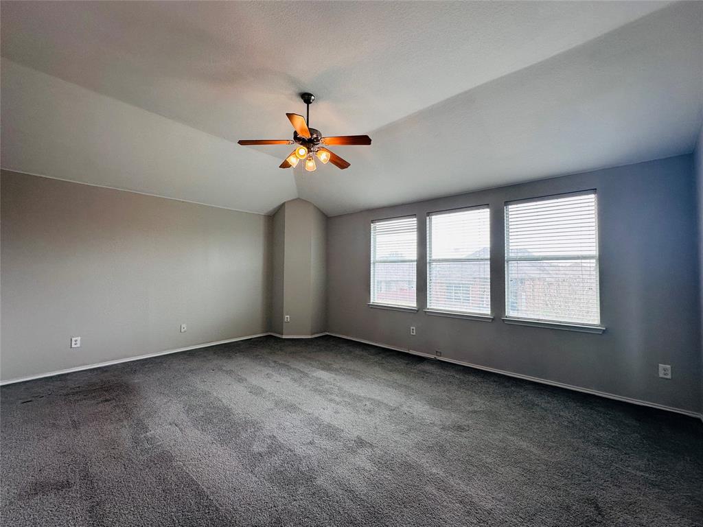 213 Spruce Trail Forney, TX 75126 - Photo 10 of 19 an empty room with windows and chandelier fan