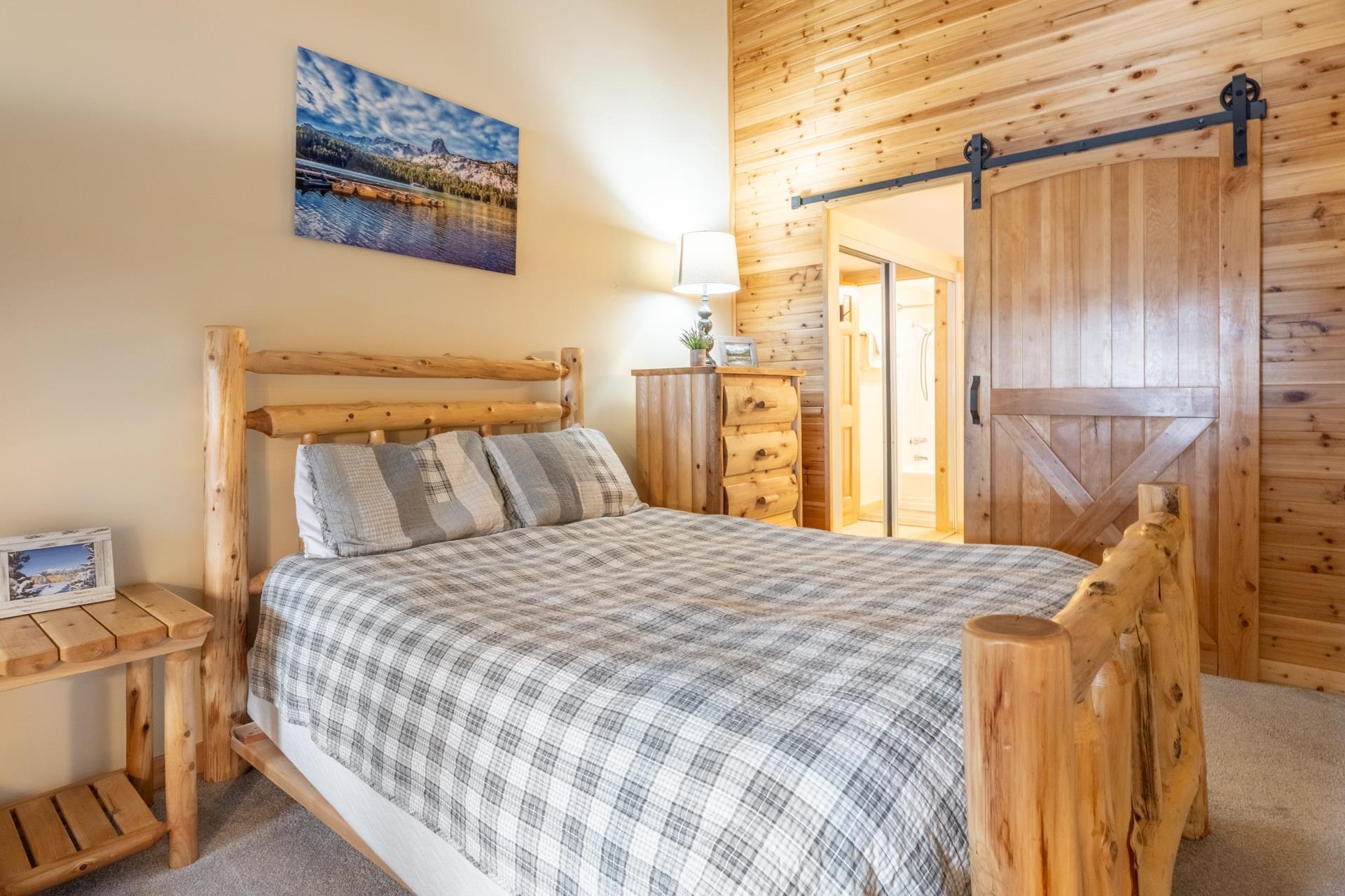 150 Sierra Park Road, Unit 6 Mammoth Lakes, CA 93546 - Photo 26 of 31 Carpeted bedroom featuring a barn door, ensuite bathroom, and wooden walls