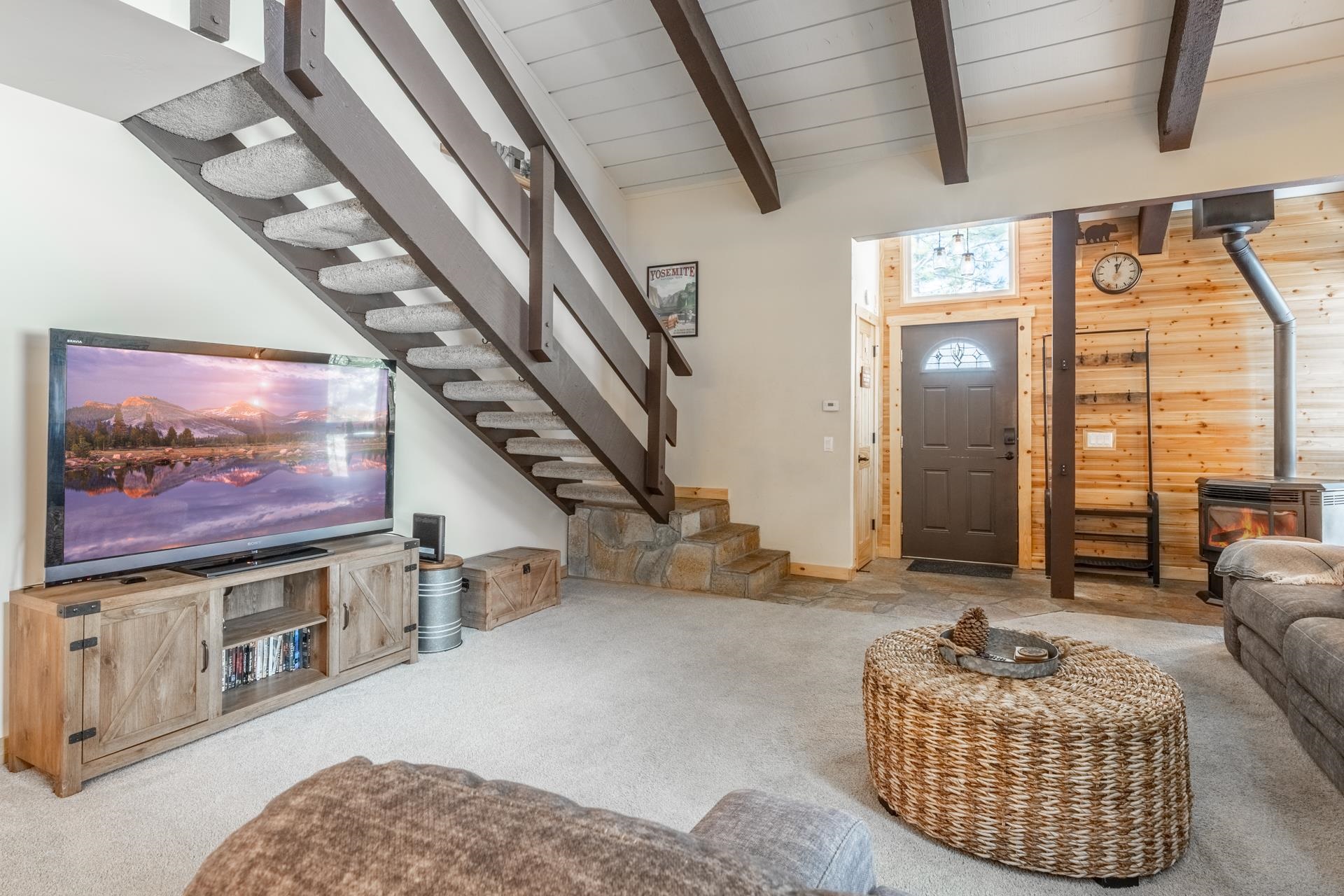 150 Sierra Park Road, Unit 6 Mammoth Lakes, CA 93546 - Photo 3 of 31 Living room featuring a wood stove, carpet flooring, and wooden walls
