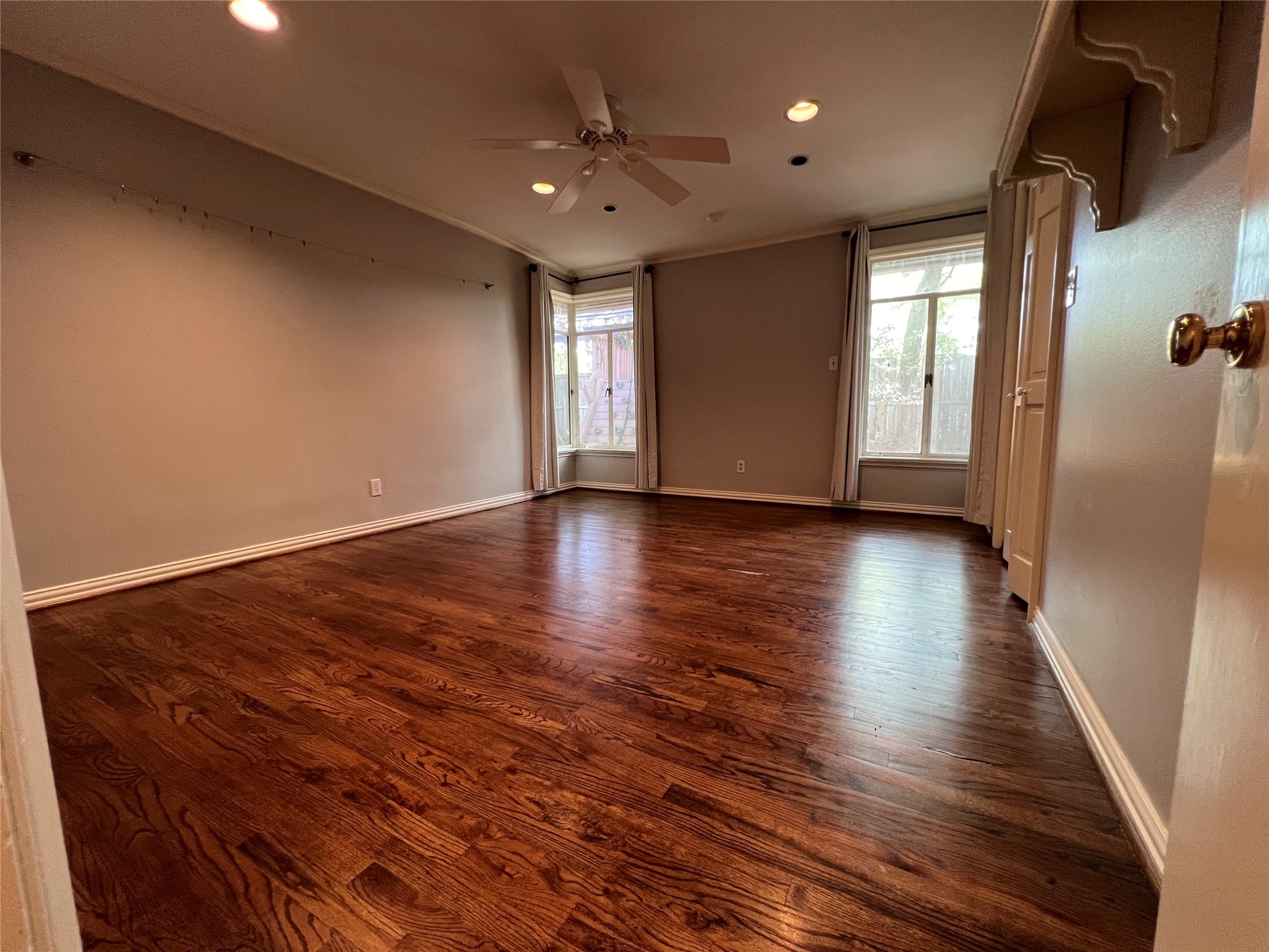 12502 Taylorcrest Road Houston, TX 77024 - Photo 19 of 28 The 3rd bedroom has hardwood floors, recessed lighting, corner windows with custom draperies and ceiling fan